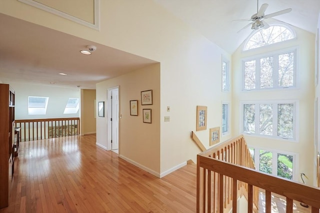 8 Fieldstone Ln, Natick, MA 01760 - corridor with baseboards, high vaulted ceiling, an upstairs landing, and light wood-style flooring