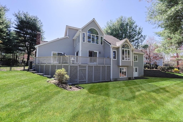 8 Fieldstone Ln, Natick, MA 01760 - back of property featuring a lawn, a deck, and fence