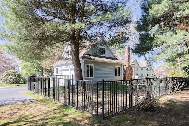 8 Fieldstone Ln, Natick, MA 01760 - back of house with fence private yard, a garage, and a chimney