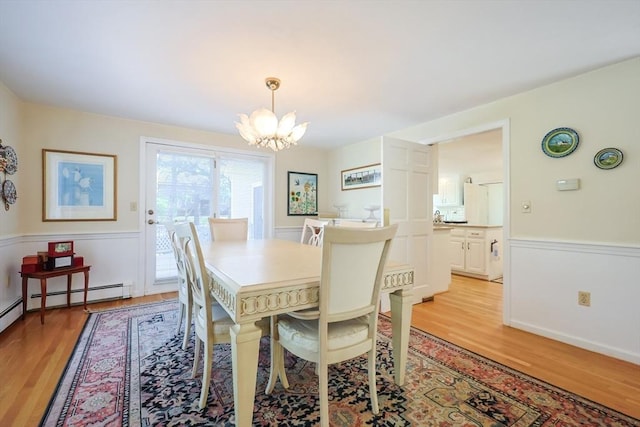 8 Fieldstone Ln, Natick, MA 01760 - dining area with a wainscoted wall, light wood-style flooring, and a chandelier