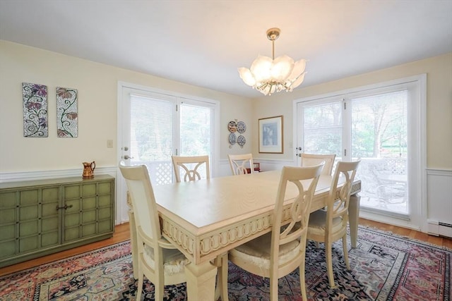 8 Fieldstone Ln, Natick, MA 01760 - dining area with an inviting chandelier, light wood-type flooring, a wealth of natural light, and a wainscoted wall