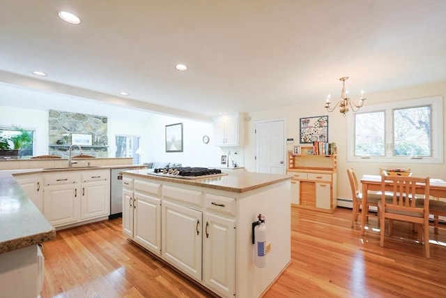 8 Fieldstone Ln, Natick, MA 01760 - kitchen featuring an inviting chandelier, light wood-style floors, white cabinets, and a center island