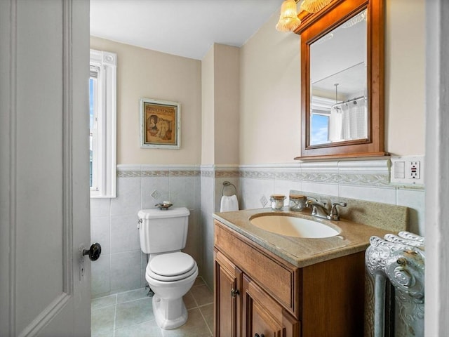 28 Albano St, Boston, MA 02131 - bathroom featuring tile patterned flooring, tile walls, toilet, vanity, and wainscoting