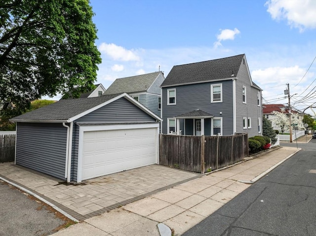 28 Albano St, Boston, MA 02131 - traditional-style house with fence, driveway, roof with shingles, an outdoor structure, and an attached garage