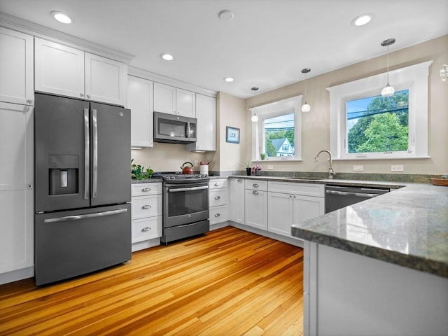 28 Albano St, Boston, MA 02131 - kitchen featuring stainless steel appliances, a sink, white cabinets, light wood-style flooring, and recessed lighting