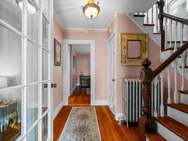 28 Albano St, Boston, MA 02131 - entryway with radiator, stairs, wood finished floors, ornamental molding, and baseboards