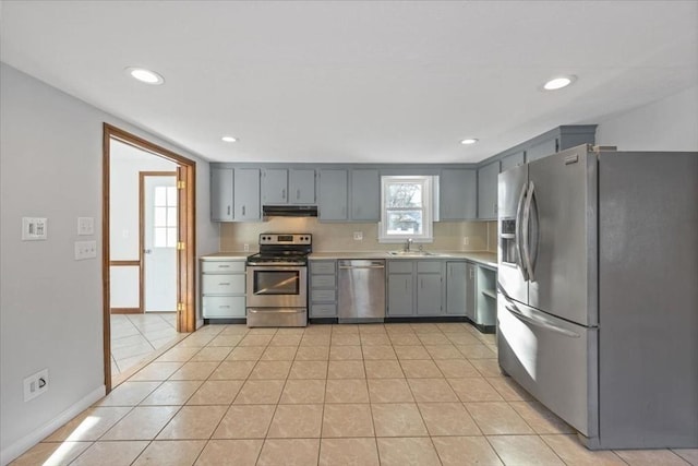 kitchen featuring sink, gray cabinets, stainless steel appliances, and light tile patterned flooring