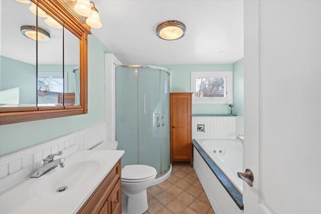 full bathroom with tile patterned flooring, vanity, shower with separate bathtub, and toilet