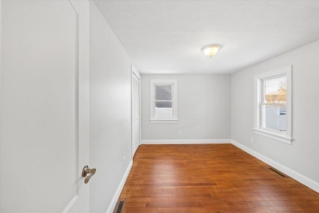 empty room with wood-type flooring