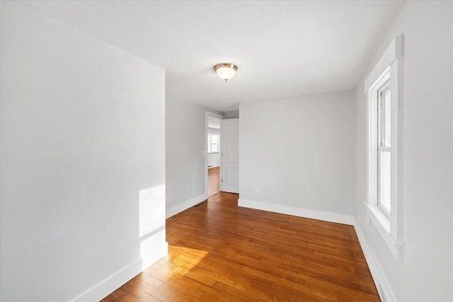 spare room featuring hardwood / wood-style flooring and plenty of natural light