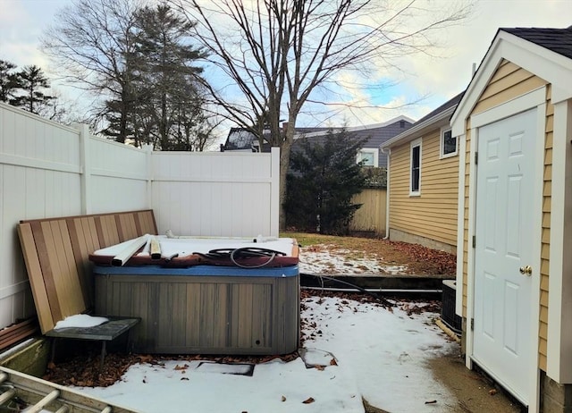 snow covered patio with a hot tub