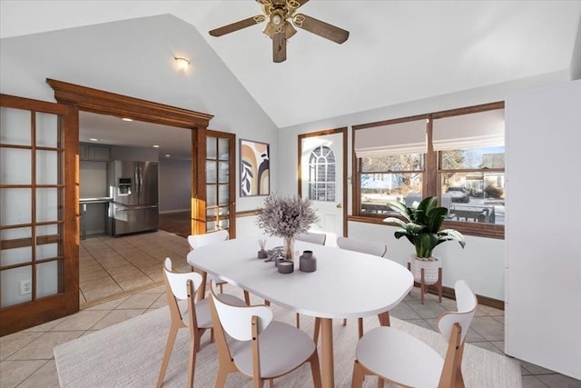 tiled dining area featuring ceiling fan and high vaulted ceiling