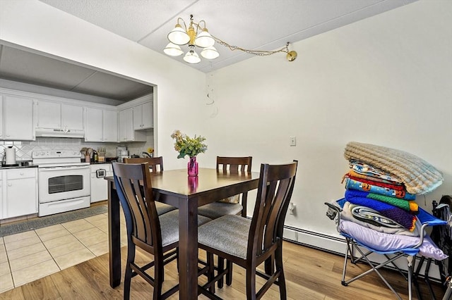 80 N Warren St Unit 14, Woburn, MA 01801 - dining area featuring a chandelier, a baseboard heating unit, and light wood-style floors