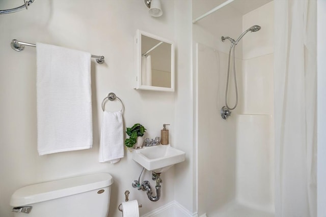 bathroom with toilet and curtained shower