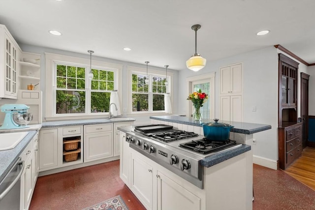 41 Bancroft St, Watertown, MA 02472 - kitchen with appliances with stainless steel finishes, white cabinets, hanging light fixtures, a center island, and glass insert cabinets