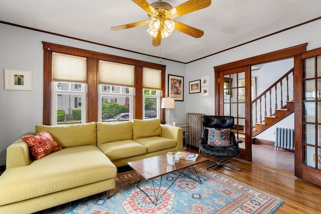41 Bancroft St, Watertown, MA 02472 - living area with radiator, healthy amount of natural light, wood finished floors, a ceiling fan, and crown molding