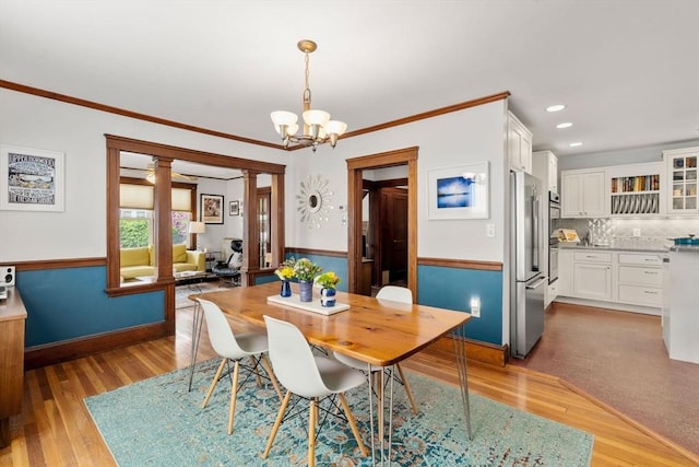 41 Bancroft St, Watertown, MA 02472 - dining space with a chandelier, light wood-style floors, ornamental molding, a wainscoted wall, and baseboards