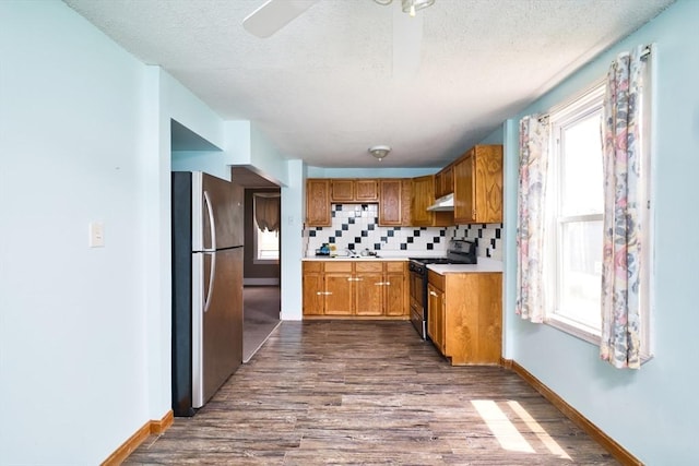 101 Cory St, Fall River, MA 02720 - kitchen featuring freestanding refrigerator, black gas range, dark wood-type flooring, a textured ceiling, and a sink