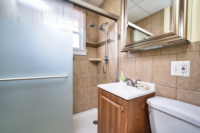 101 Cory St, Fall River, MA 02720 - bathroom featuring a tile shower, toilet, vanity, and tile walls