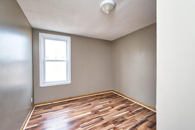101 Cory St, Fall River, MA 02720 - unfurnished room featuring wood finished floors, a textured ceiling, and baseboards