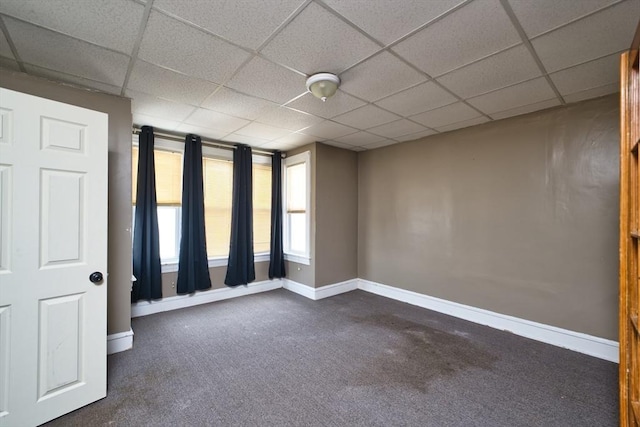 101 Cory St, Fall River, MA 02720 - unfurnished room with baseboards, dark carpet, and a drop ceiling