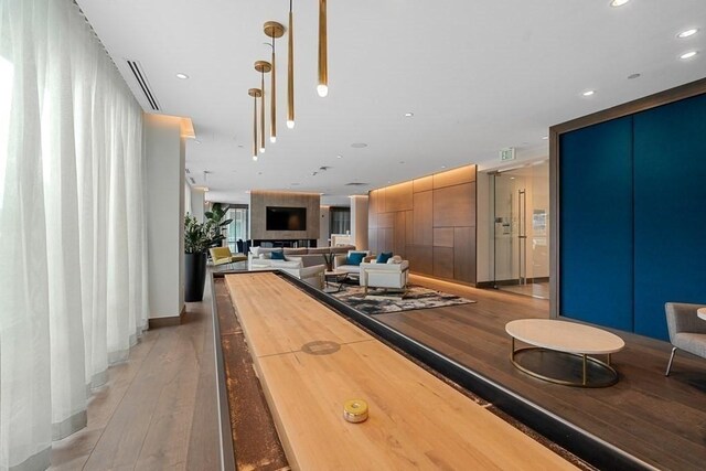 recreation room featuring light wood-style flooring, visible vents, and recessed lighting