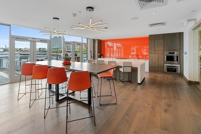 dining room with a view of city, plenty of natural light, and visible vents
