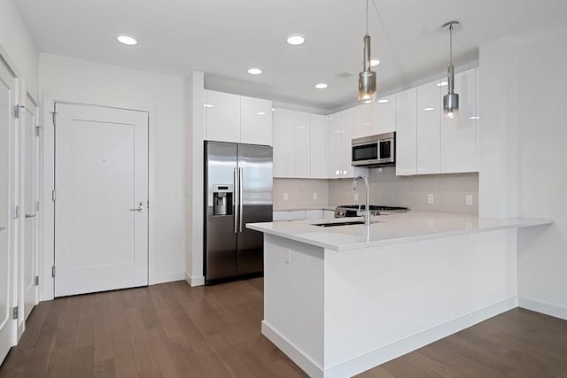 kitchen featuring dark wood-style flooring, light countertops, modern cabinets, and appliances with stainless steel finishes