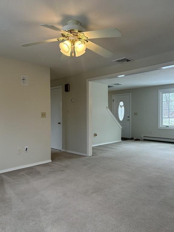 unfurnished room featuring baseboards, a baseboard radiator, visible vents, and light colored carpet