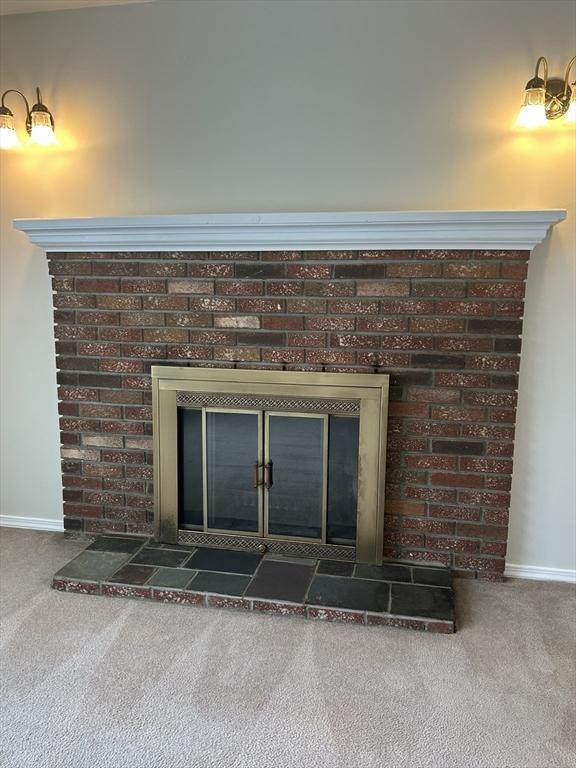 details with carpet floors, a fireplace, and baseboards