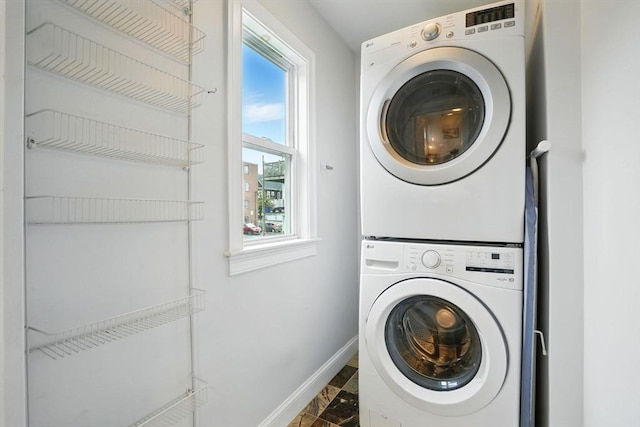 33 Century St Unit 3, Somerville, MA 02145 - laundry room with stacked washing machine and dryer and baseboards