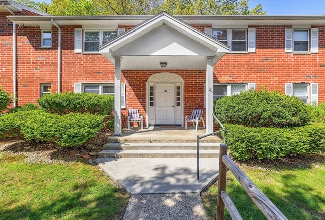 120 Litchfield Pines Dr Unit A, Leominster, MA 01453 - view of front facade with brick siding and a porch