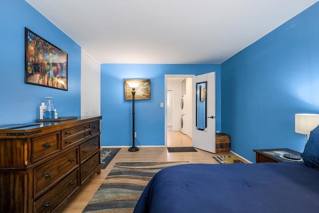 120 Litchfield Pines Dr Unit A, Leominster, MA 01453 - bedroom with light wood-type flooring, stacked washer / drying machine, and baseboards