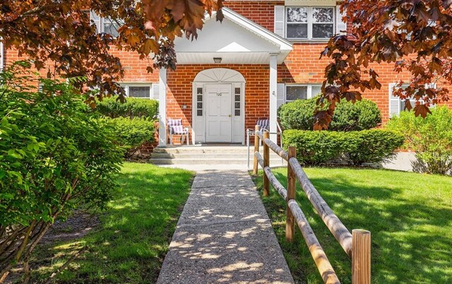 120 Litchfield Pines Dr Unit A, Leominster, MA 01453 - doorway to property with brick siding and a lawn