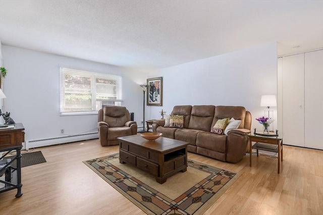 120 Litchfield Pines Dr Unit A, Leominster, MA 01453 - living area featuring a baseboard heating unit and light wood-type flooring