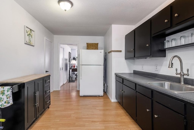 120 Litchfield Pines Dr Unit A, Leominster, MA 01453 - kitchen featuring freestanding refrigerator, a sink, light wood-style floors, open shelves, and dark cabinetry