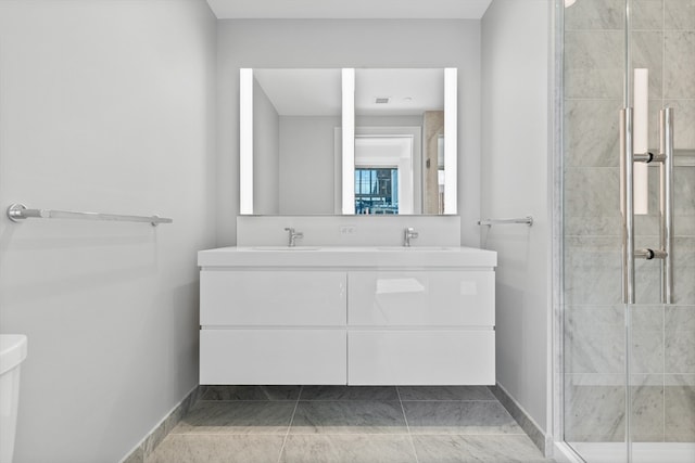 bathroom featuring vanity, a shower with shower door, and tile patterned flooring