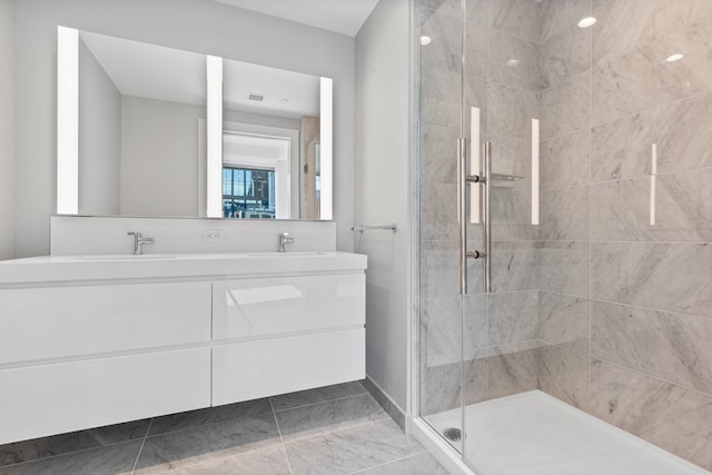 bathroom featuring tile patterned flooring, vanity, and a shower with shower door