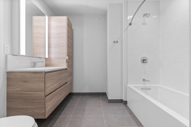 full bathroom with vanity, tiled shower / bath combo, toilet, and tile patterned floors