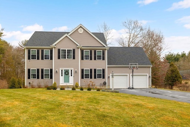 colonial home with a garage and a front lawn