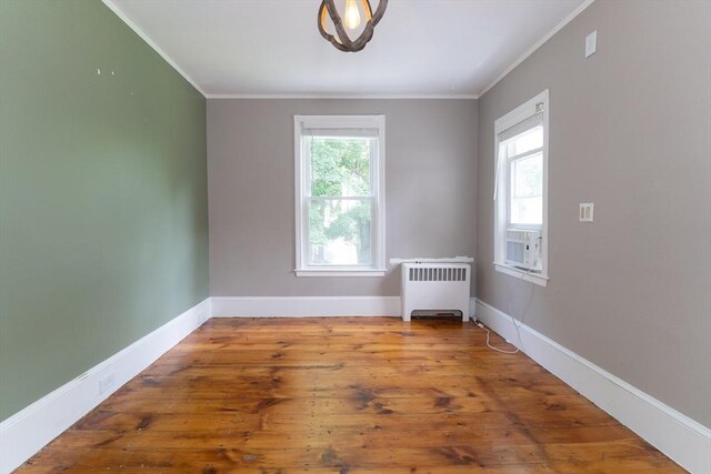 1 Commonwealth Ave, Sturbridge, MA 01518 - empty room with radiator, crown molding, and hardwood / wood-style flooring