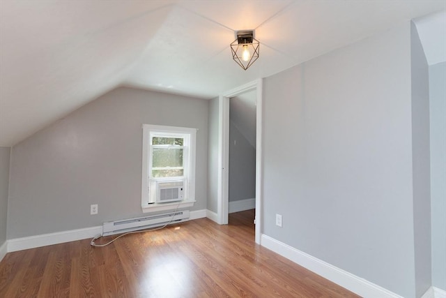 1 Commonwealth Ave, Sturbridge, MA 01518 - additional living space featuring a baseboard heating unit, vaulted ceiling, wood finished floors, and cooling unit