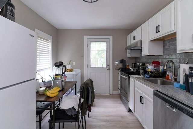 1 Commonwealth Ave, Sturbridge, MA 01518 - kitchen with appliances with stainless steel finishes, washer and dryer, under cabinet range hood, and white cabinetry
