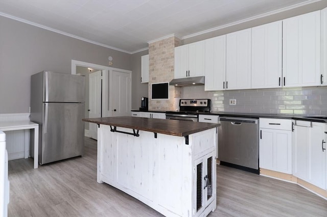 1 Commonwealth Ave, Sturbridge, MA 01518 - kitchen featuring stainless steel appliances, under cabinet range hood, butcher block countertops, light wood-style floors, and crown molding