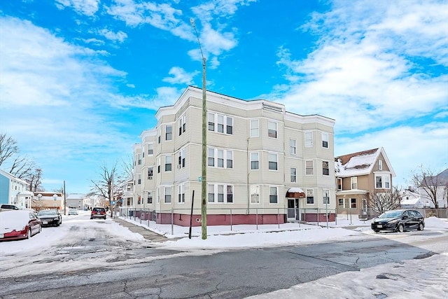 snow covered property with a residential view