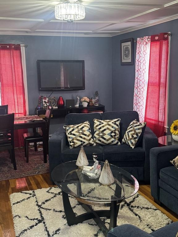 living room with dark wood-type flooring and a chandelier