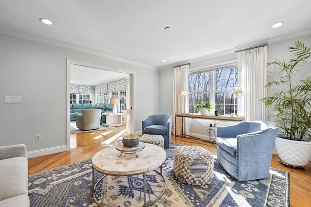 living room featuring baseboards, wood finished floors, recessed lighting, and crown molding