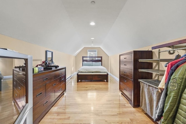 bedroom featuring baseboards, vaulted ceiling, light wood-style flooring, and recessed lighting