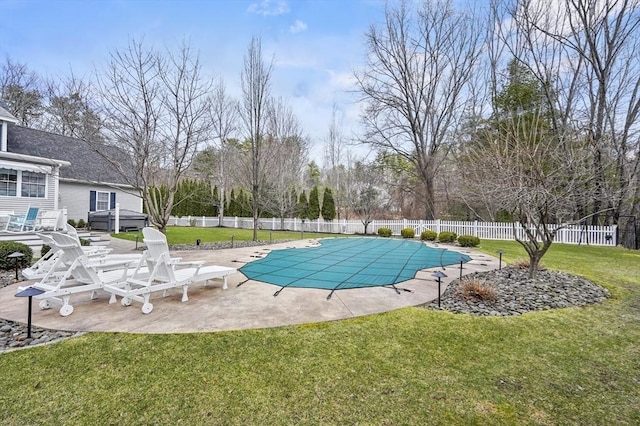 view of swimming pool featuring a patio area, a fenced in pool, fence, grilling area, and a yard