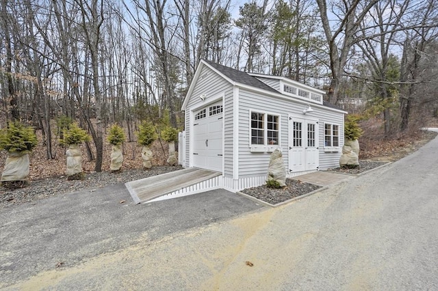 garage featuring aphalt driveway